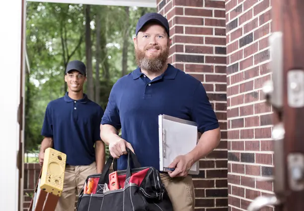 Experienced security technician assisting a homeowner with alarm system setup