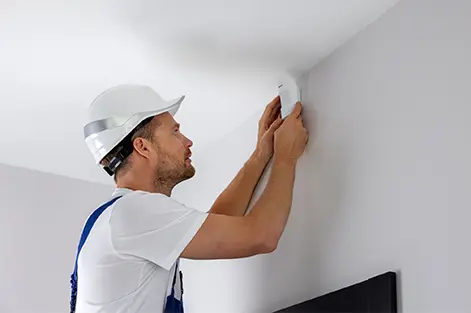 Advanced motion detectors installed in a commercial hallway for 24/7 intrusion protection.