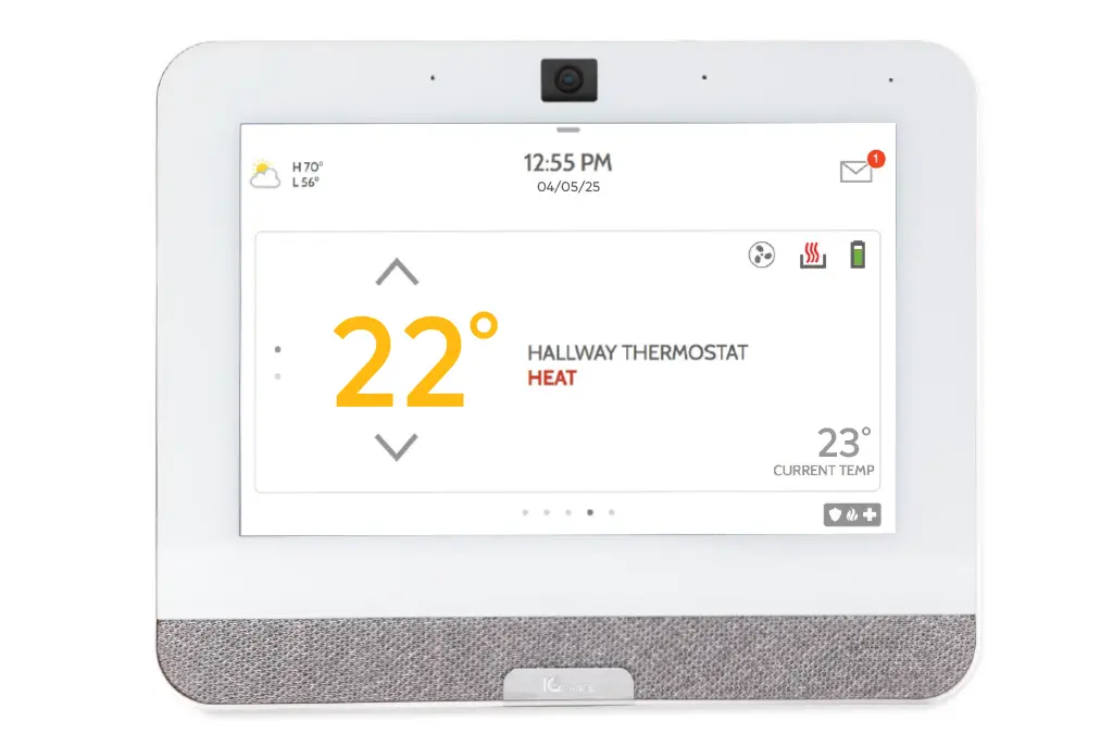 Smart thermostat touchscreen panel displaying home temperature and heating status