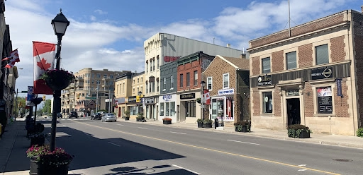 Scenic view of downtown Aurora Ontario showing local shops and Canadian flags along the main street